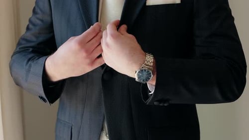 Fashionable Man in Suit Buttons His Vest