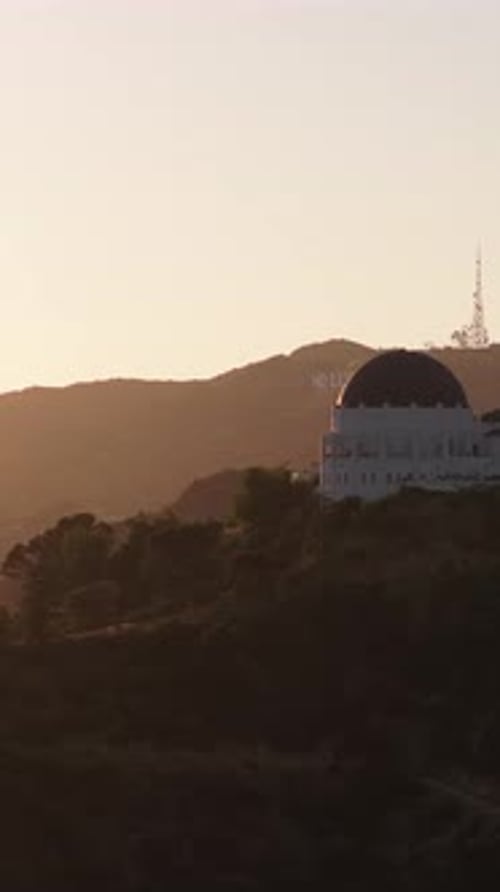Warm Golden Sunset Casting a Silhouette of Griffith Observatory and Hollywood Sign Showing Iconic