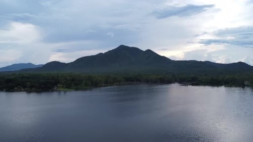 Aerial view of reservoir on tropical mountain background at sunset in northern Thailand.