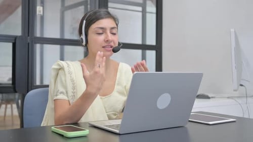 Indian Woman with Headset Talking with Customer in Call Center