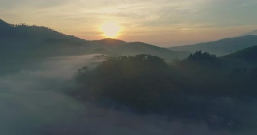 Aerial View of Foggy Mountains at Sunrise