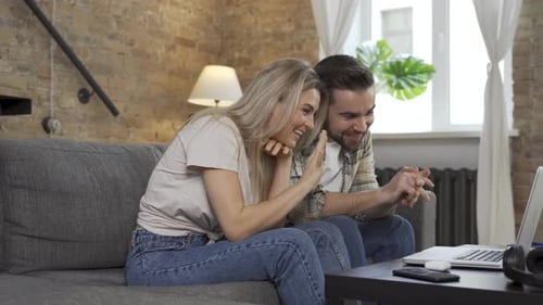 Happy Couple Using Laptop for Video Call in the Living Room