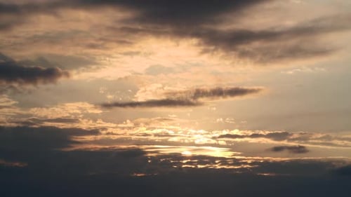 Sunset, Time Lapse of Bright Yellow Sunset Sun Moving Across Cloudy Sky Background