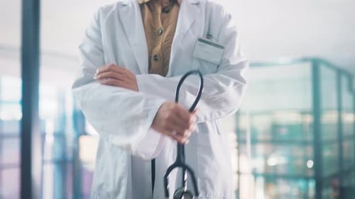 Doctor, arms crossed and stethoscope in hospital, hands and employee for healthcare