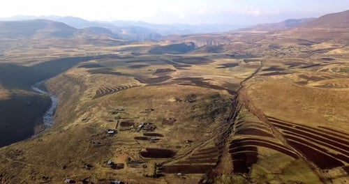 Rural Valley Landscape Featuring Terraced Fields and Village