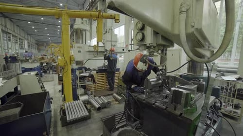 Metal Industry Workers Operating a Hydraulic Press in a Factory Stock Clip