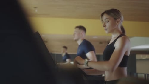 Woman Walking on Gym Treadmill