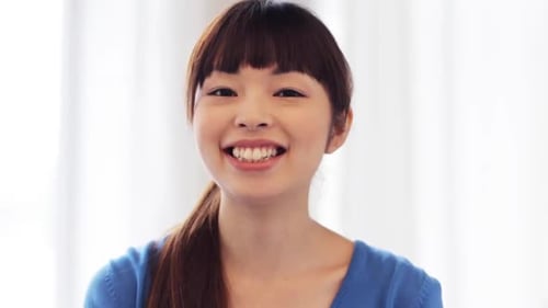 Smiling young woman looking at the camera