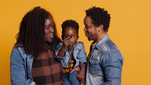 Happy Family Singing Together with Microphone in Studio
