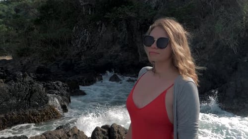 Woman on Rocky Beach with Waves