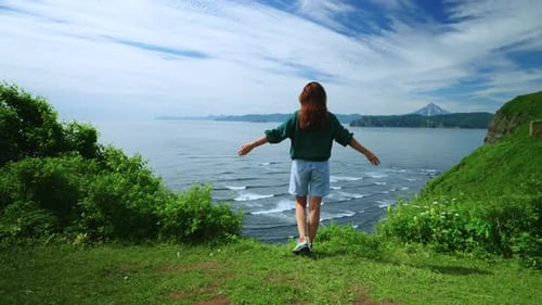 Young Woman Tourist Admiring Seascape From Mountains Lady Putting Hands Up Cinematic Back View