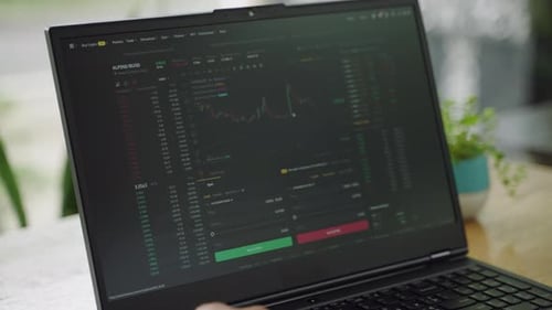 Laptop Displaying Crypto Stock Information on Screen