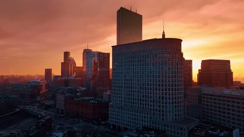 Boston downtown architecture at the backdrop of orange sky.