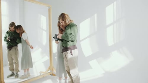 Female Model and Photographer Discussing Photos on Camera in Studio