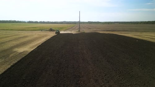 Tractors plowing the field in Ukraine