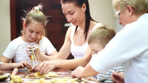 Family Baking Together at the Kitchen Table