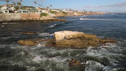 Splashing Ocean Waves At Bird Rock On La Jolla With Beachfront In Distance In San Diego, California.