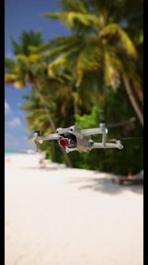 Drone Hovering Over a Tropical Beach on Sunny Day