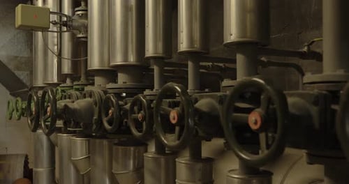 Row of Industrial Valves and Pipes