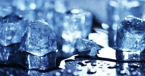 Close-up of Melting Ice Cubes on Black Surface