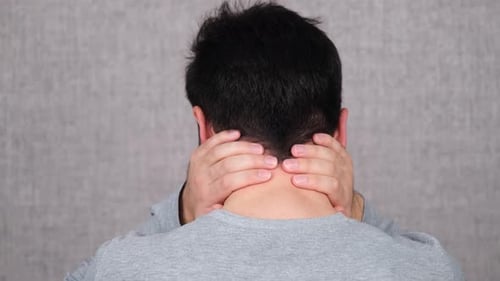 Adult Massaging Sore Neck with Both Hands