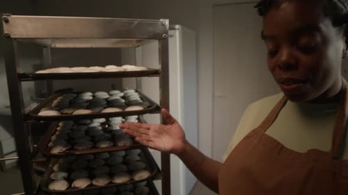 Baker Displaying Baked Goods in Commercial Kitchen