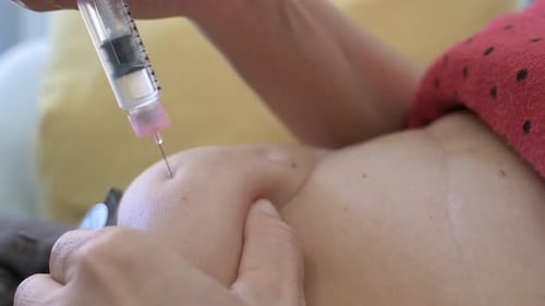 Close Up of Syringe Injection into Abdomen