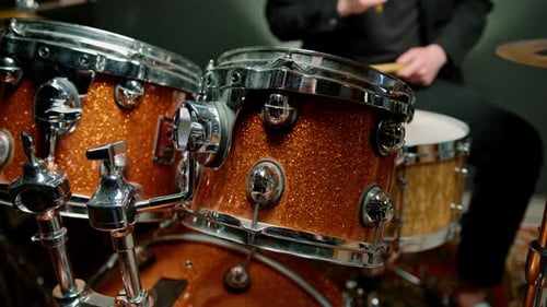drummer plays a drum kit in a recording studio at a professional musician rehearsal recording a song