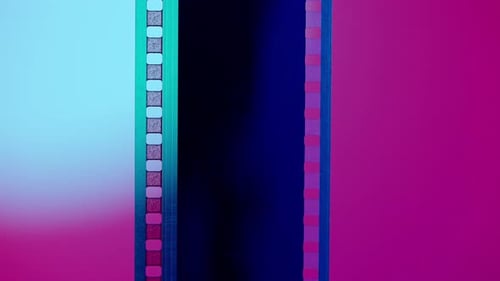 Vertical Film Strip on a Pink Background with White Circular Light Close Up 35Mm Film Slide Frame