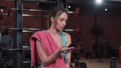 Serious Young Woman Use Phone in Sport Gym Girl Sport Fitness Workout Exercise Healthy Body Active