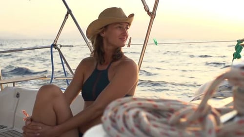 Happy Woman Enjoying Sailing Boat on Sea During Sunset 30s