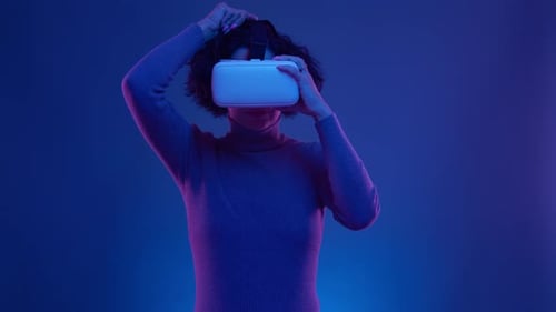 Cyber Gamer in VR Glasses Plays Virtual Reality Game in Neon Futuristic Space