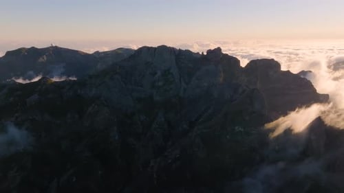 Majestic mountain peaks under a golden sunrise in high-altitude landscape