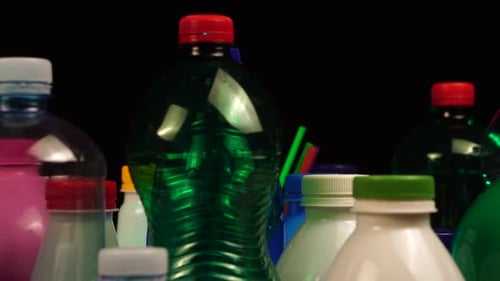 Used Plastic Bottles and Straws in Different Shapes and Colors, Close Up