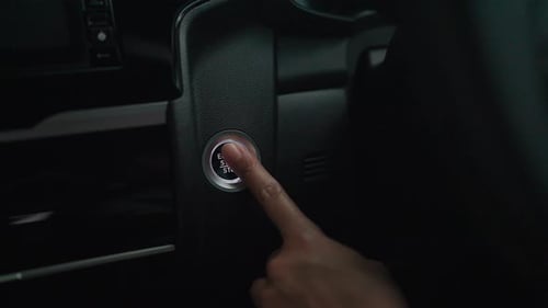 Hand push to start car engine Follow to button Finger presses the button to start the car engine. Dr