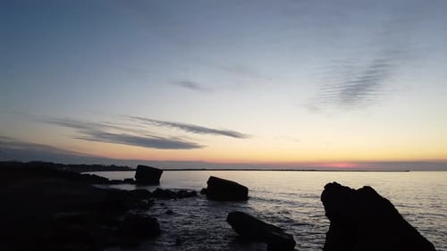 Beautiful vibrant high contrast sunset low altitude flyover over the Karosta war port concrete coast