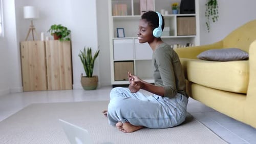 Young Woman Listening to Music at Home