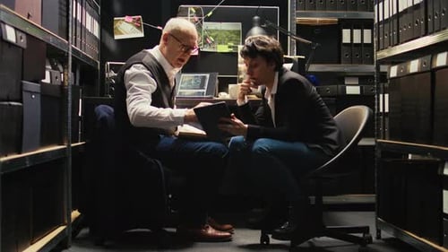 Tense Office Meeting in a Cramped File Room