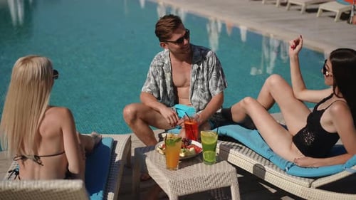 Enjoying a Relaxing Poolside Gathering Filled with Laughter and Meaningful Moments Among Friends