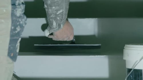 Man Smoothing Compound on Staircase Step