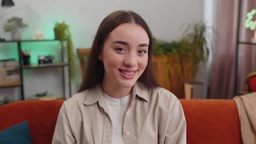 Smiling Woman With Brown Hair Sitting on Couch