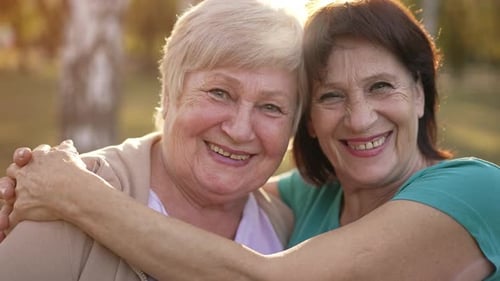 Two Women Smiling Together in a Park