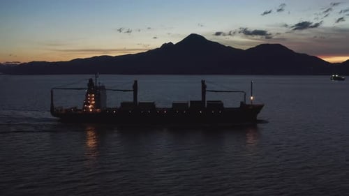 Logistics Freight Ship Motors Out at Night heading towards South China Sea