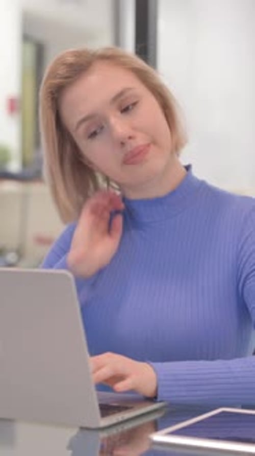 Woman Uses Laptop then Stretches Neck at Desk