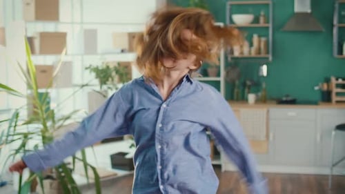 Red-Haired Woman Dancing with Joy Indoors