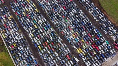 Rows of parked cars in a large lot during the day