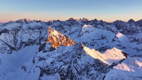 Aerial views of stunning Alps at sunset showcasing majestic mountain peaks