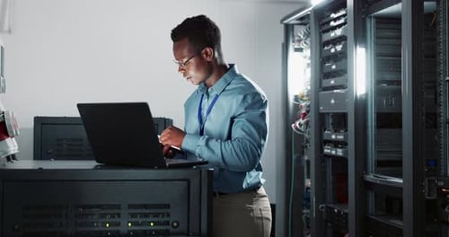 Technician Working in Modern Server Room