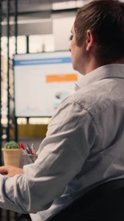 Vertical Video Working Alone in Office Businessman Does Analysis Charts and Graphs