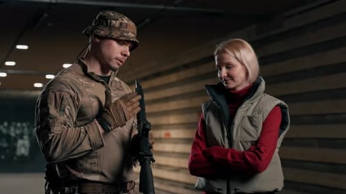 Man in Military Gear Talking to Woman